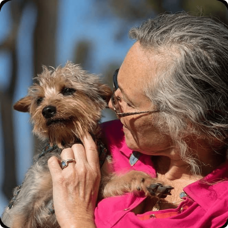 happy volunteer comforting dog